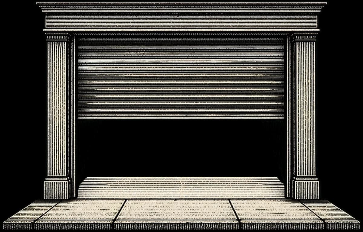 A roller shutter part-raised, light spilling underneath